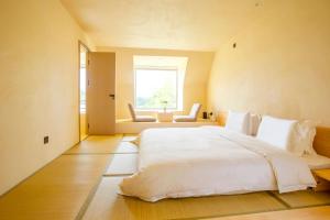 Postel nebo postele na pokoji v ubytování Shanghai Xingshe Camping B&B Disney Branch