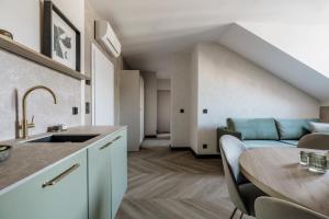 a kitchen and living room with a table and a couch at Millou - LoftAffair Collection in Kraków +201 photos