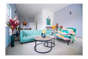 杜阿拉Villa Trinidad的客厅里有一张蓝色的沙发和一张桌子