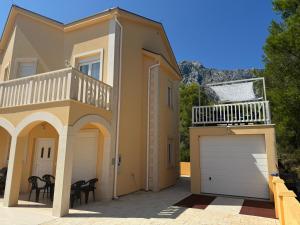 a house with a garage and a balcony at Villa Sunshine in Orebić