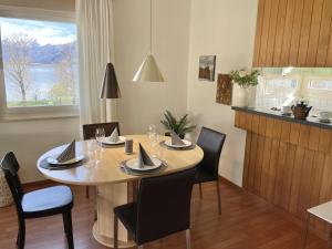 a dining room with a table and chairs and a window at Al Lido by Fewotessin in Locarno