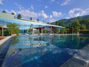 a large swimming pool in front of a building at Al Lido by Fewotessin in Locarno