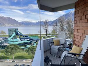 a view from a balcony with a water slide at Al Lido by Fewotessin in Locarno