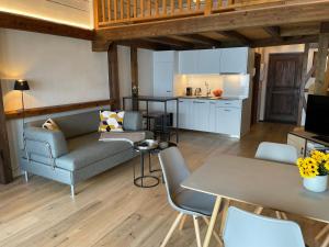 a living room with a couch and a table at Belvedere by Fewotessin in Orselina +14 photos
