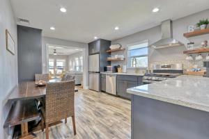 a large kitchen with a counter and a dining room at Bridge Haus in New Braunfels