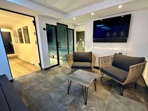a living room with two chairs and a table at Chalet des rêves in Megève +14 photos