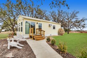 a tiny house with a porch and a deck at Kara's Cottage in Johnson City