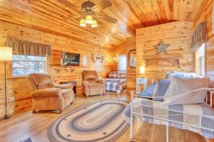 a log cabin living room with a bed and chairs at Kara's Cottage in Johnson City +8 photos