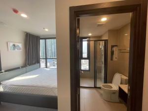 a bedroom with a bed and a shower and a toilet at 小太阳民宿 in Bangkok