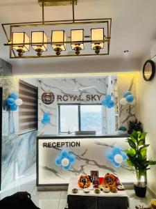 a room with a table with blue balloons on it at Hotel Royal Sky in Morbi