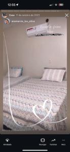 a picture of a bed in a room with a website at Taiba suítes temporada in Acarape