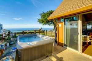 a hot tub on the deck of a house at Private Beach Access Pet-Friendly California Gem! in Manchester