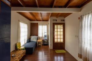 a living room with a couch and a table at Villa Kayu Ciwidey in Panundaan