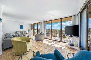 a living room with a couch and a tv at Our House at the Beach 201W by Beachside Management in Siesta Key