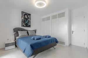 a bedroom with a bed with a blue blanket at Blue apartment with One bedroom, WiFi and amazing view in Chayofa +25 photos