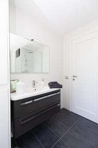 a bathroom with a sink and a mirror at L'isola di Kalyta in Lido di Ostia +23 photos