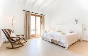a white bedroom with a bed and a chair at Pula Bonavista Ref 140 in Costa des Pins +20 photos