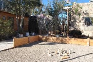 a backyard with a wooden fence and a sandbox at Maison Sidi et Lalla in Essaouira