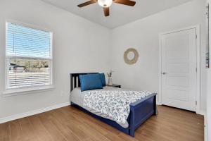 a bedroom with a bed and a ceiling fan at Oasis by the Lake in Canyon Lake