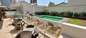 a balcony with chairs and a swimming pool at Excluído por Problemas !! in Campinas