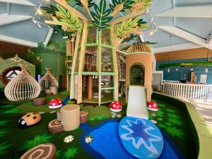 a room with a toy house with a water slide at The Waterfront in South Cerney