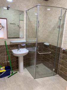 a bathroom with a glass shower and a sink at Quiet quarter and private beach in Hurghada +21 photos
