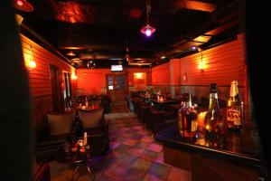a restaurant with a bar with tables and chairs at Hotel Aishwaryaa in Erode