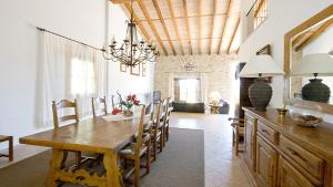 a dining room with a wooden table and chairs at Finca Horlandis Ref 133 in Son Servera