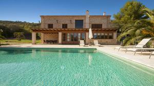 a villa with a swimming pool in front of a house at Finca Horlandis Ref 133 in Son Servera