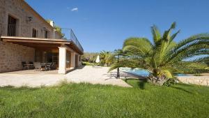a house with a patio and a palm tree in the yard at Finca Horlandis Ref 133 in Son Servera