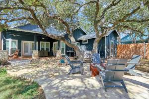 a patio with chairs and a tree in front of a house at Haydon House in Dripping Springs