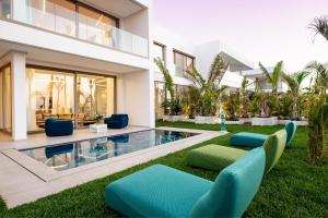 a villa with a swimming pool and a house at LE BLEU RESORT in Tangier