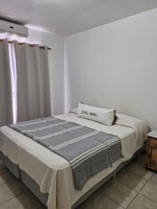 a bed in a room with a box on it at Amplio Duplex frente a Parque Benegas in Godoy Cruz