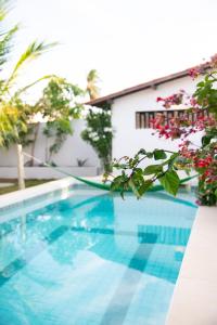 a swimming pool in front of a house at Casa CLAUDIA in Fortim