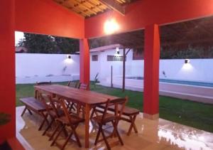 a wooden table and chairs in a house at Casa CLAUDIA in Fortim