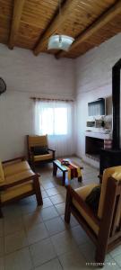 a living room with two chairs and a couch at Sol y Paz Valle Grande San Rafael in San Rafael