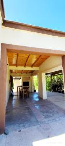 an empty patio with a table and a wooden ceiling at Sol y Paz Valle Grande San Rafael in San Rafael