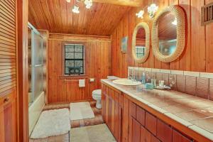 a bathroom with a toilet and a sink and mirror at Rocky Mountain in New Braunfels +35 photos