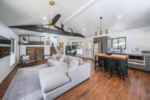 a living room with a couch and a kitchen at Texas Retreat - Sunset Rock in Wimberley