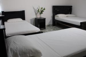 Postel nebo postele na pokoji v ubytování Hotel Beijing Cartagena