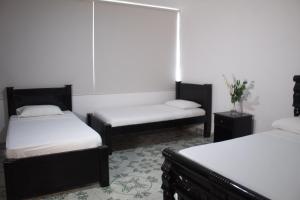 Postel nebo postele na pokoji v ubytování Hotel Beijing Cartagena