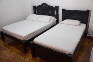 Postel nebo postele na pokoji v ubytování Hotel Beijing Cartagena