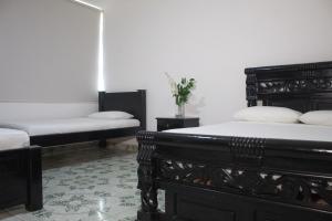 Postel nebo postele na pokoji v ubytování Hotel Beijing Cartagena