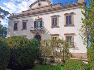 a large white building with a balcony on it at Villa Donna Anna in Assisi