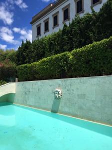 a swimming pool in front of a white building at Villa Donna Anna in Assisi
