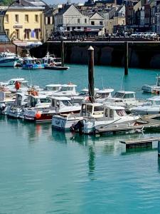 a bunch of boats are docked in a harbor at Le Sémaphore in Fécamp