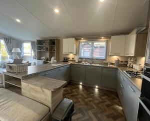 a kitchen with white cabinets and a counter top at 1 Bullrush in Tattershall +9 photos