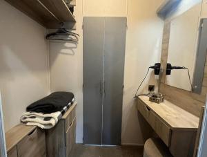 a bathroom with a shower and a sink and a mirror at 1 Bullrush in Tattershall