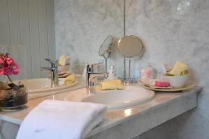 a bathroom counter with two sinks and a mirror at Christian Gartenhotel in Nieder-Olm +48 photos