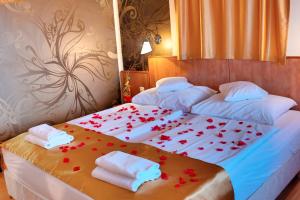 a bedroom with two beds with red hearts on them at Aqua Therm Hotel in Zalakaros +44 photos